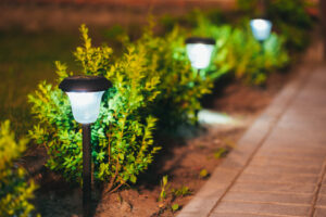 Small Solar Garden outdoor Lighting, Lantern In Flower Bed. Garden Design.